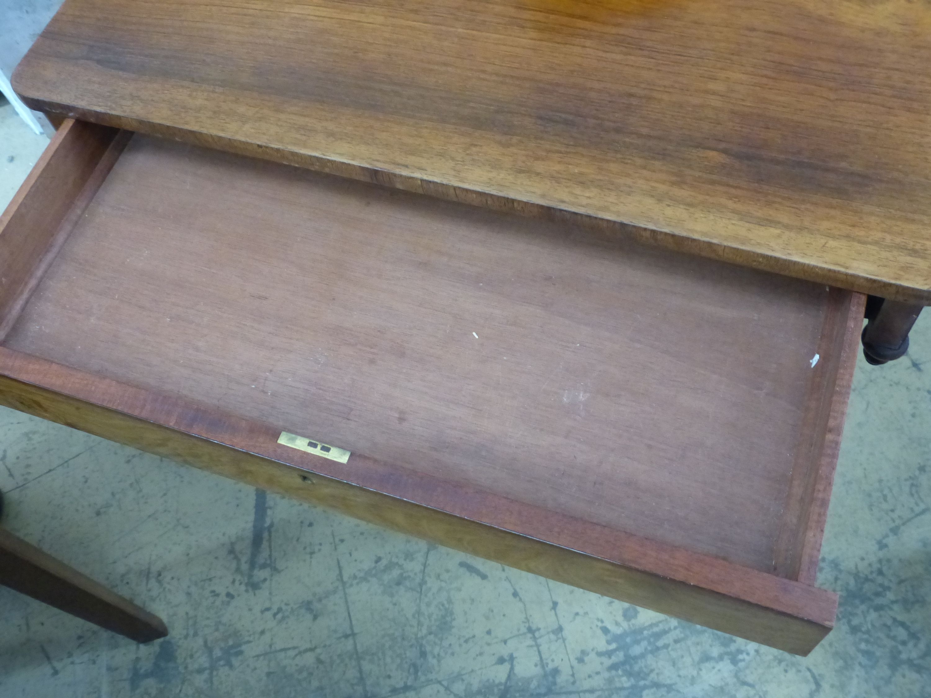 A Victorian rosewood side table, on end standard supports, width 66cm, depth 45cm, height 72cm